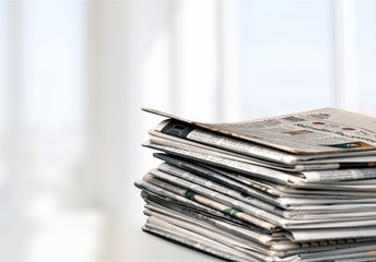 Pile of newspapers on white background
