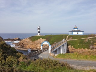 Fototapeta na wymiar Old and new lighthouse on Isla Pancha, Ribadeo, Lugo, Spain.