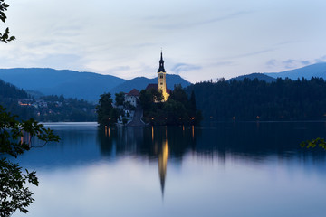 Fototapeta na wymiar Summer evening on the lake Bled with a view on the Bled island with Pilgrimage Church of the Assumption of Maria