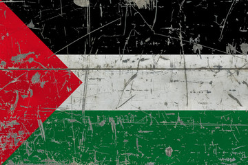 Grunge Palestine flag on old scratched wooden surface. National vintage background.