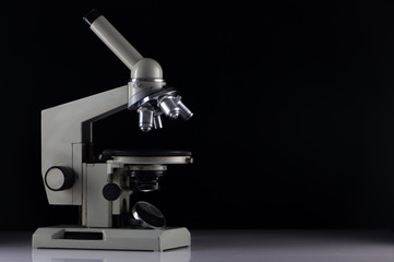 white microscope on dark background. Close up