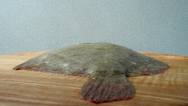 Fish of flatfish on a cutting board.
