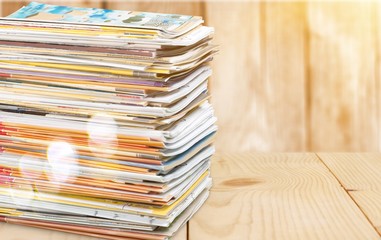 Pile of newspapers on white background