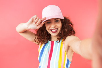 Smiling pretty redhead woman wearing in dress and cap
