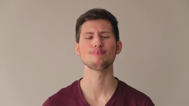 Young male model making funny faces and being foolish