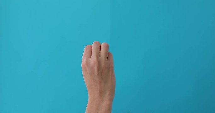 Closeup of isolated on blue adult female hand counting from 0 to 5. Woman shows fist fist, then one, two, three, four, five fingers. Manicured nails painted with beautiful polish