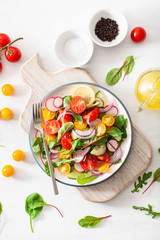 Fototapeta na wymiar healthy colorful vegan tomato salad with cucumber, radish, onion