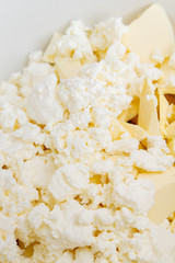 In a mixing bowl are the ingredients butter and cottage cheese for making cookies