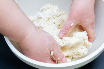 Mixing in a bowl of dough for the preparation of cottage cheese cookies