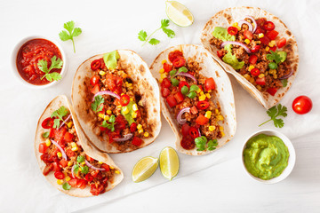 mexican beef and pork tacos with salsa, guacamole and vegetables