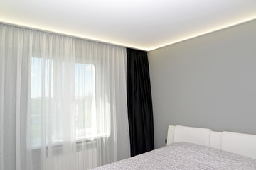 Bedroom interior fragment with a black portiere