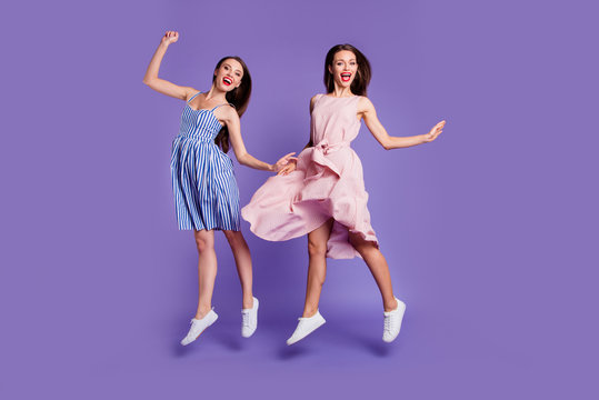 Full length body size photo two people beautiful funky she her models chic ladies jumping high best cheerleaders fans celebrating breakthrough wear summer dresses isolated purple violet background