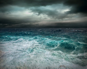 Obraz na płótnie Canvas Stormy sea view near coastline at evening time. Waves, splashed