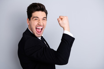 Close up portrait emotional millennial chairmen executive feel thrilled scream shout yeah raise fists expression impressed celebration contract modern classic outfit isolated grey background