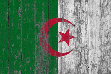 Flag of Algeria painted on worn out wooden texture background.