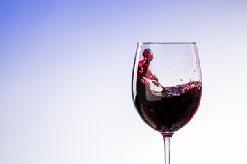 red wine in a glass with a splash
