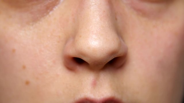 Person flares their nostrils.