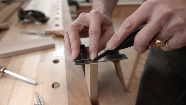 Woodworker accurately measures and scribes end of lumber.