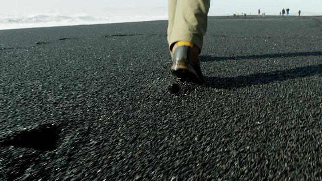 Footsteps Track Walking Across Black Sand Beach, Iceland.