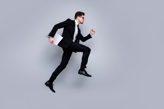 Full length body size profile side view portrait of his he nice attractive purposeful guy professional executive manager banker carrying laptop career growth isolated over light gray background