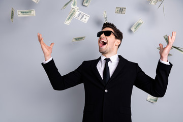 Portrait of his he nice elegant attractive cheerful guy sales manager financier banker economist director throwing away currency lottery credit win winner isolated over light gray background