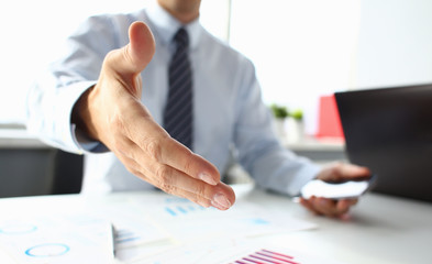 Man in suit and tie give hand as hello in office closeup. Friend welcome, mediation offer, positive introduction, thanks gesture, summit participate approval, motivation, male arm, strike bargain