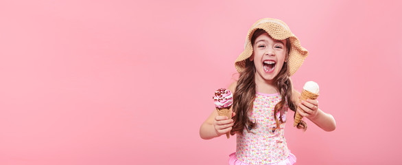 Cute little girl with ice cream on pink background