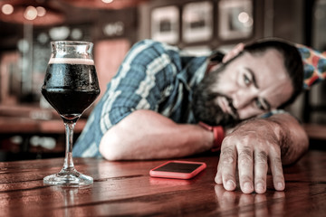 Unhappy birthday celebrant lying on a pub table.