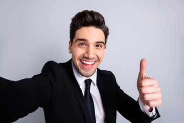 Close up photo amazing he him his macho handsome make take selfies thumb raised up advising buy buyer product funny funky wear white shirt black suit jacket tie formalwear isolated grey background