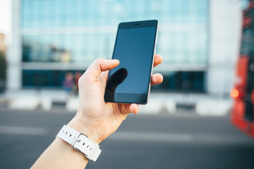 Female's hand holding smart phone