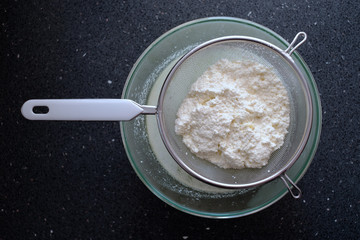 Freshly made ricotta cheese in a sieve