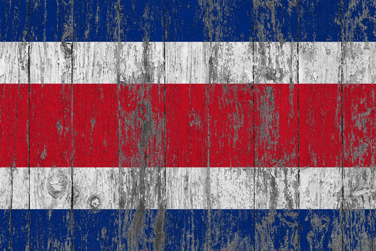 Flag of Costa Rica painted on worn out wooden texture background.