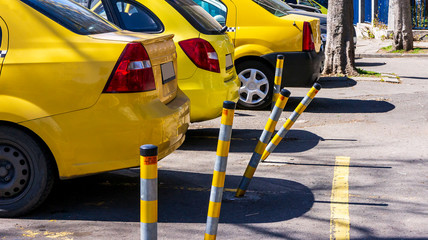 twisted yellow street pins. car drivers and taxis hit safety pins. broken frames distorted by strikes.