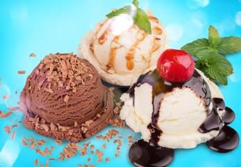 Ice cream scoops  with vanilla, chocolate and berry scoops and topping