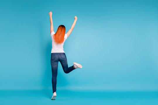 Back rear behind view photo  charming cute lady glad candid positive long haircut weekend free time content funny funky raise arms delighted lottery aim goal modern outfit isolated pastel background 