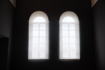 interior view in old building with two windows - soft light from window and dark in the room.