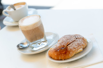 Typical Italian breakfast: espresso coffee and croissant