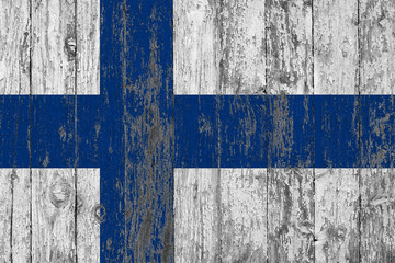 Flag of Finland painted on worn out wooden texture background.