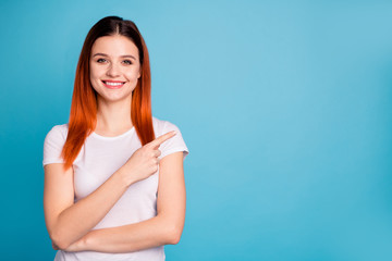 Portrait of her she nice attractive lovely winsome confident cheerful cheery girl wearing white t-shirt pointing aside ad copy space isolated over bright vivid shine blue background