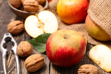 Naklejka na ściany i meble apple with walnut on wood background
