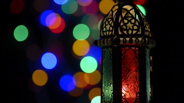 Low light studio set up shot of lighted lantern - showing ramadan kareem or eid mubarak celebration conceptual.