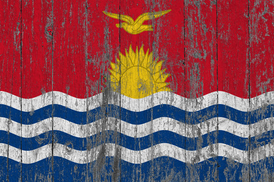 Flag of Kiribati painted on worn out wooden texture background.
