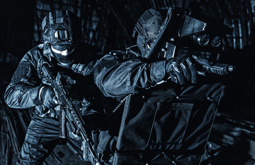 Police SWAT unit hiding behind ballistic shield