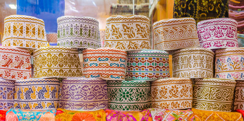 Colorful Omani Caps on retail display during Ramadan. - obrazy, fototapety, plakaty