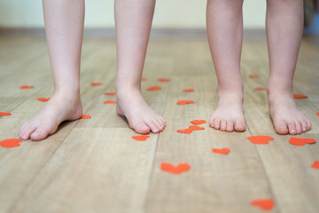 Children's feet on floor.
