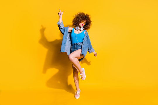 Full length body size photo funny she her lady wavy styling curls clubber sing songs hang out wear headset ear flaps specs casual jeans denim shirt shorts tank top clothes isolated yellow background
