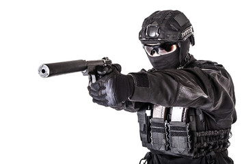 Studio portrait of SWAT officer aiming with pistol