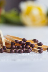a pile of matches close up on a white table. Macro fire igniter on blurred background. vertical