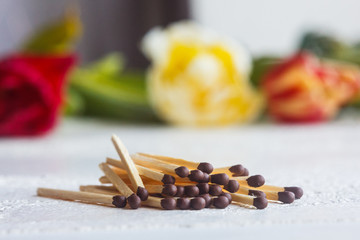 a pile of matches close up on a white table. Macro fire igniter on blurred background