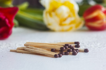 a pile of matches close up on a white table. Macro fire igniter on blurred background